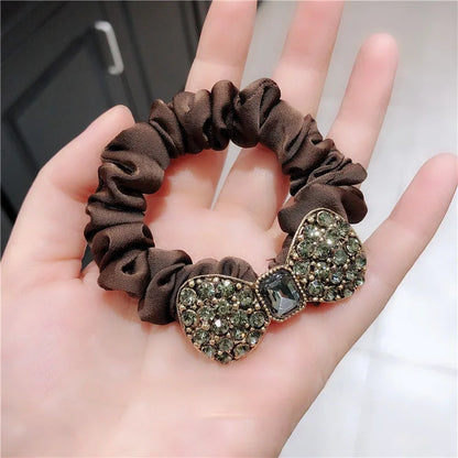 Rhinestone bow scrunchie by Edenista; brown satin band with dual crystal heart bows