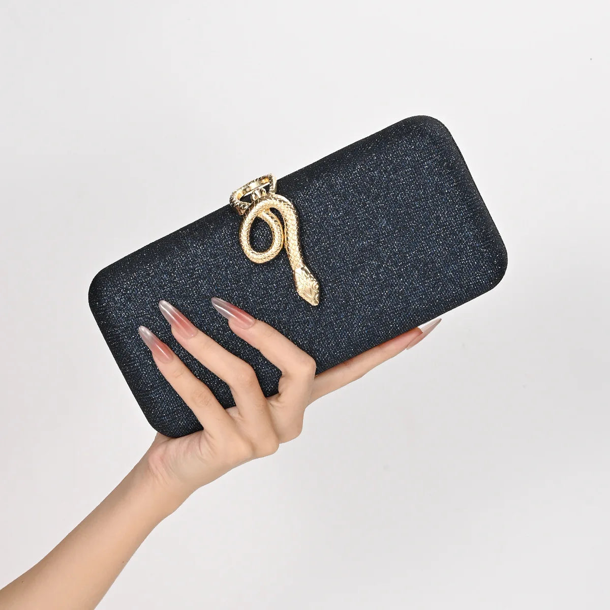 Edenista classic snake-buckle evening clutch in glittery black with gold snake ornament