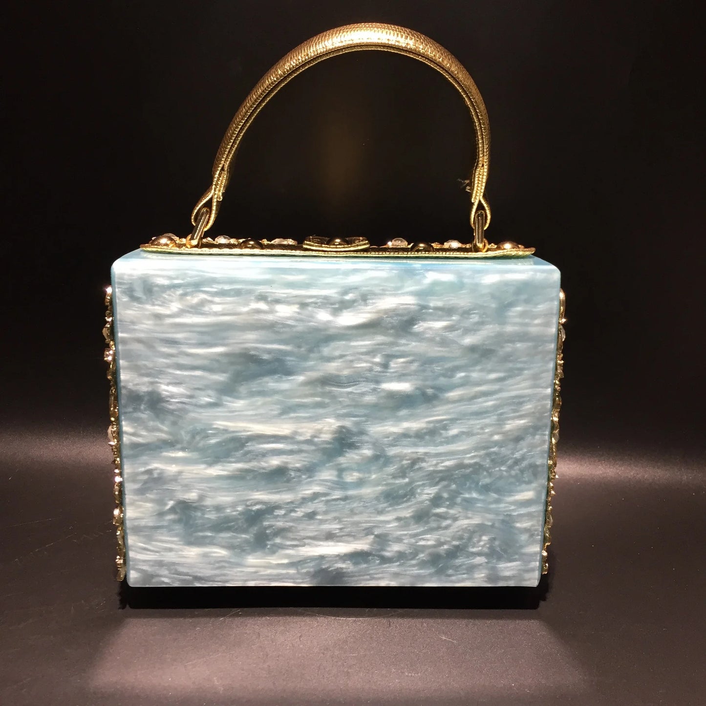 Edenista acrylic evening bag clutch with gold-tone rhinestone-trimmed handle and blue marbled body