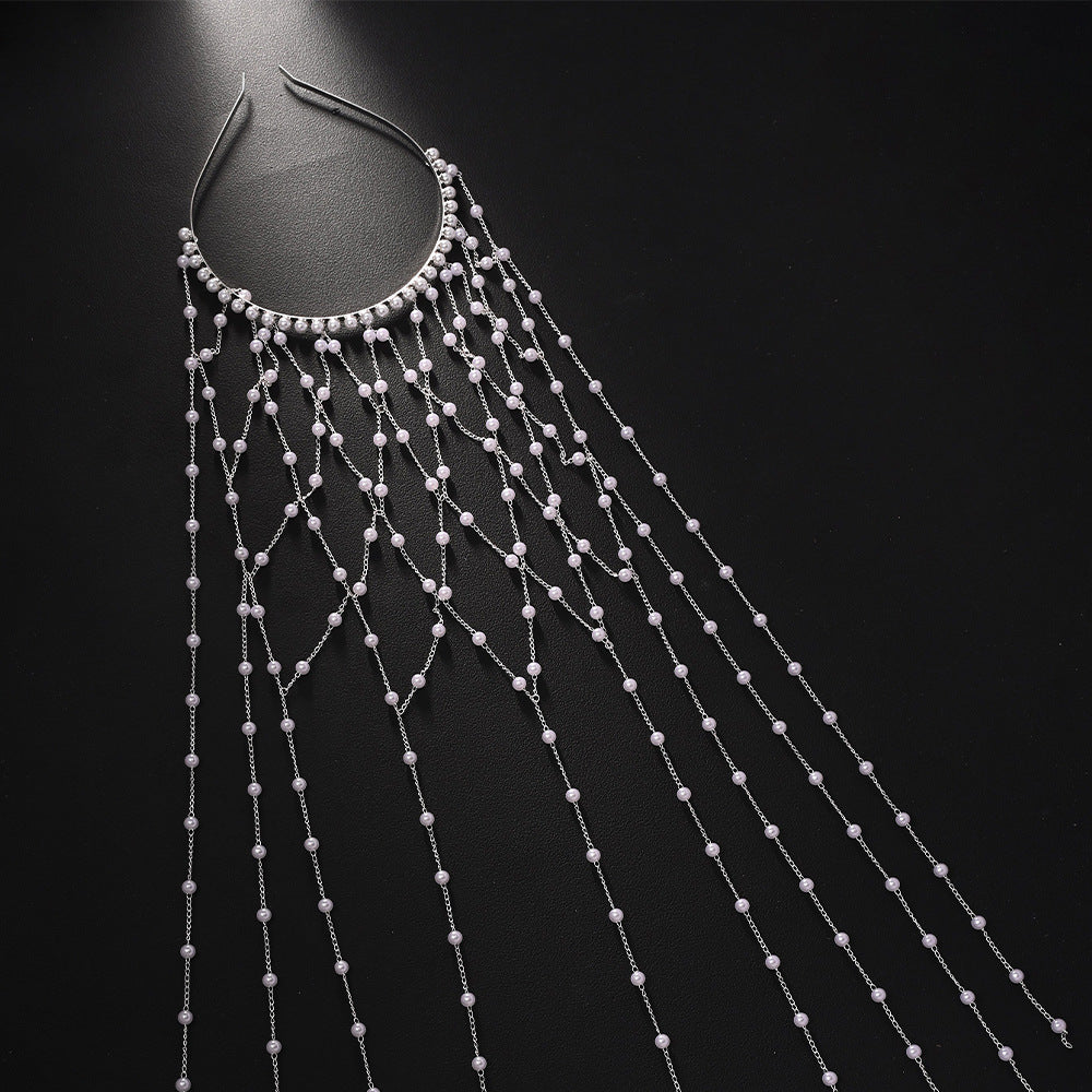 Pearl hairband accessory with cascading silver chains and beads for formal dresses