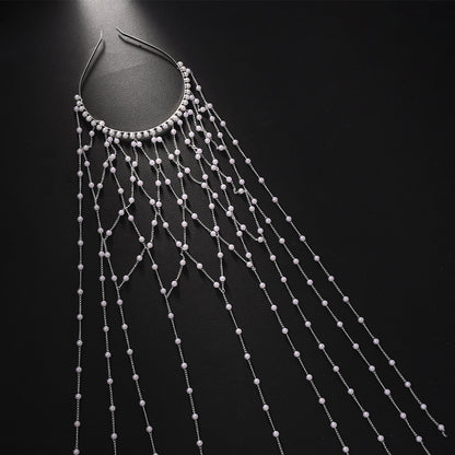 Pearl hairband accessory with cascading silver chains and beads for formal dresses