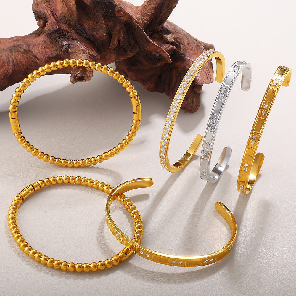 Buckle Alloy Open-End Bracelets, set of 6 gold-tone and silver-tone bangles with crystal accents.