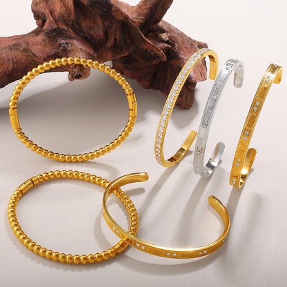 Buckle Alloy Open-End Bracelets, set of 6 gold-tone and silver-tone bangles with crystal accents.