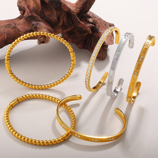 Buckle Alloy Open-End Bracelets, set of 6 gold-tone and silver-tone bangles with crystal accents.