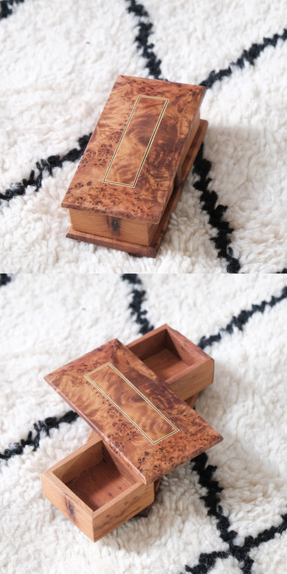 Moroccan handmade rotating wooden jewelry box with burl wood finish and gold rectangular inlay.