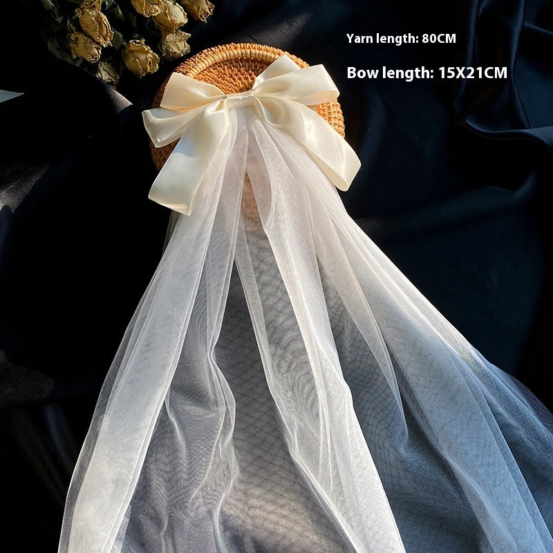 Bow Veil on woven straw hat with ivory satin bow and long white tulle veil