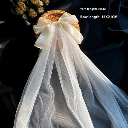 Bow Veil on woven straw hat with ivory satin bow and long white tulle veil