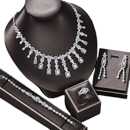 Zircon jewelry set: necklace, earrings, bracelet, ring; silver-tone with clear stones, CJ brand, 4-piece set.
