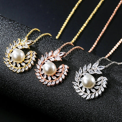 Set of three pearl pendant necklaces with laurel leaf halos in gold, rose gold, and silver by CJ