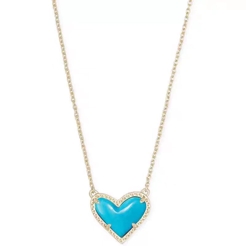 Cubic Zirconia Heart Pendant Necklace with turquoise blue heart and crystal border on a gold-tone chain.
