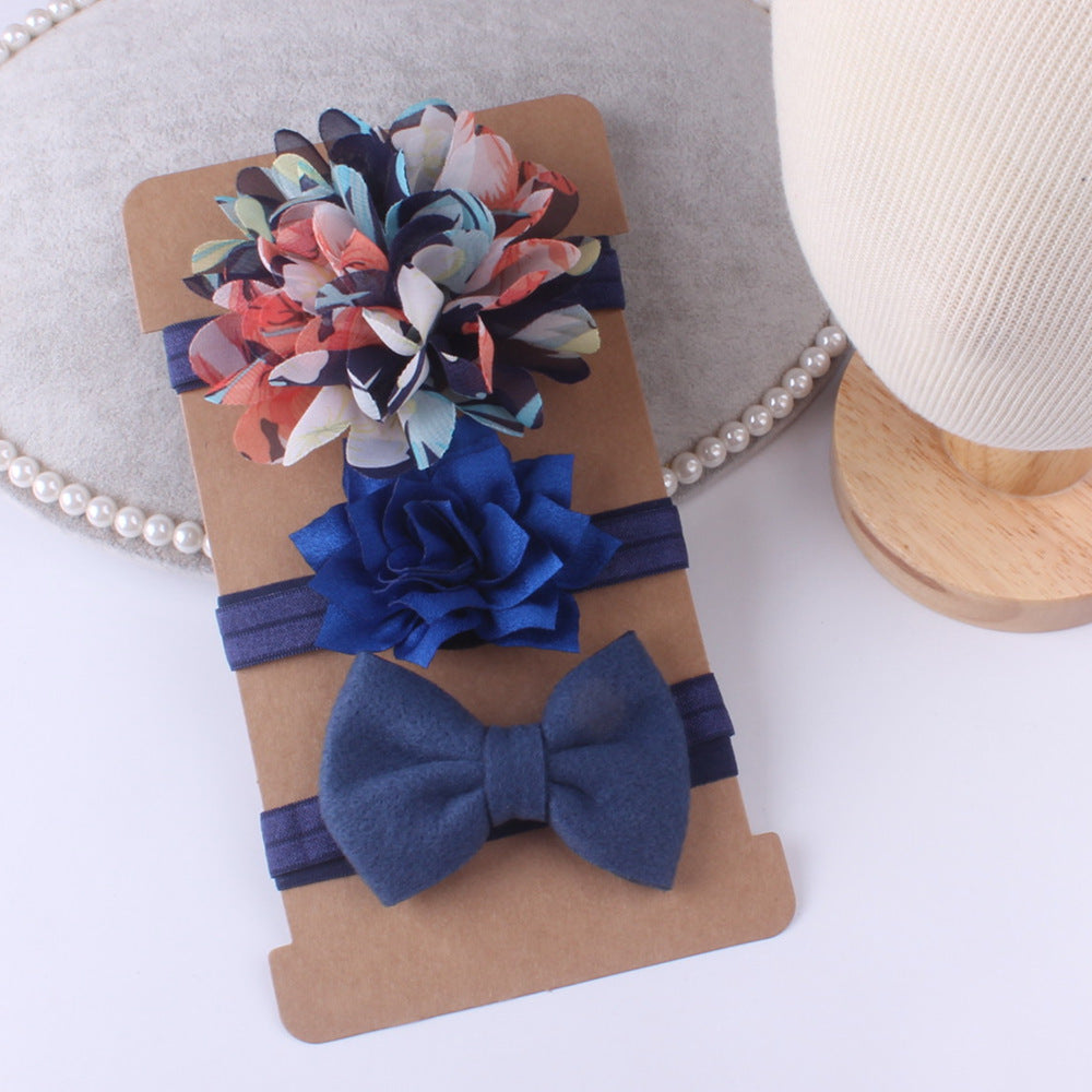 Three-piece floral baby stretch hairbands by cj; multicolor flower, blue rosette, and navy bow on elastic bands.
