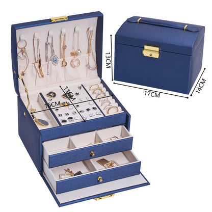 edenista blue three-layer drawer jewelry box with gold hardware and beige lining, showing necklaces and rings.