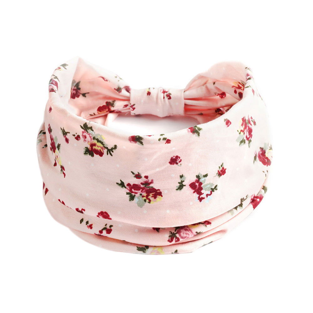 Bohemian Cashew pink floral yoga headband with knot front; soft floral print fabric.