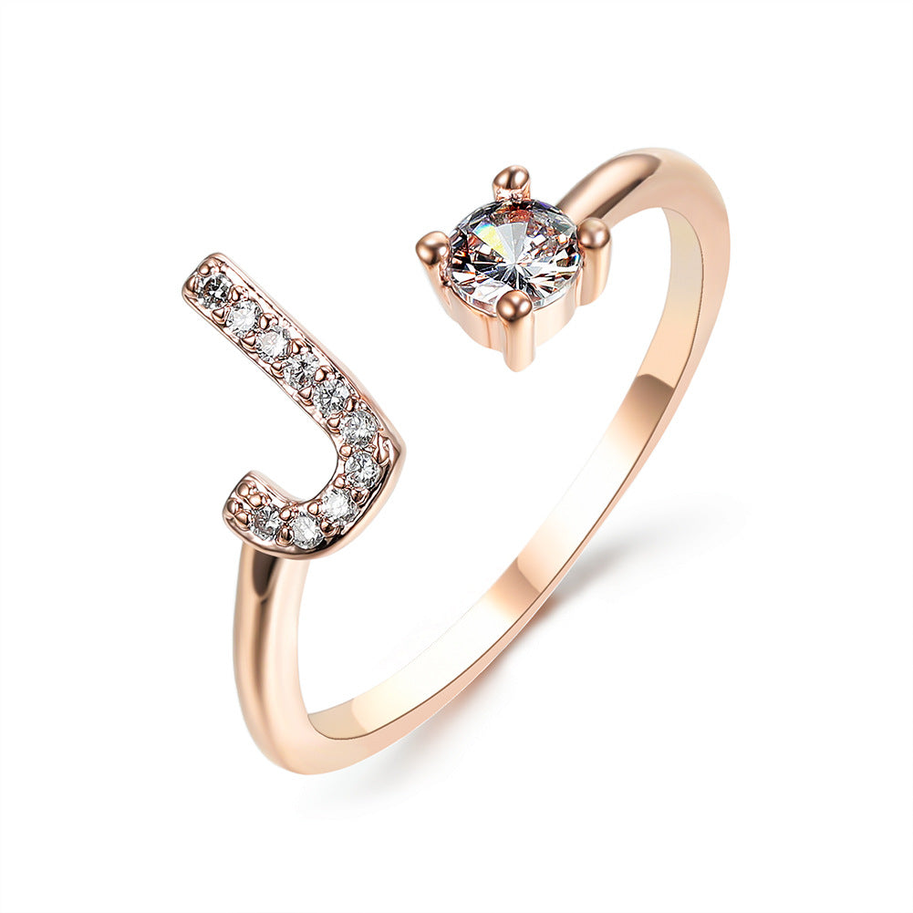 Rose gold adjustable initial J ring for women with pave crystals and a solitaire centerpiece