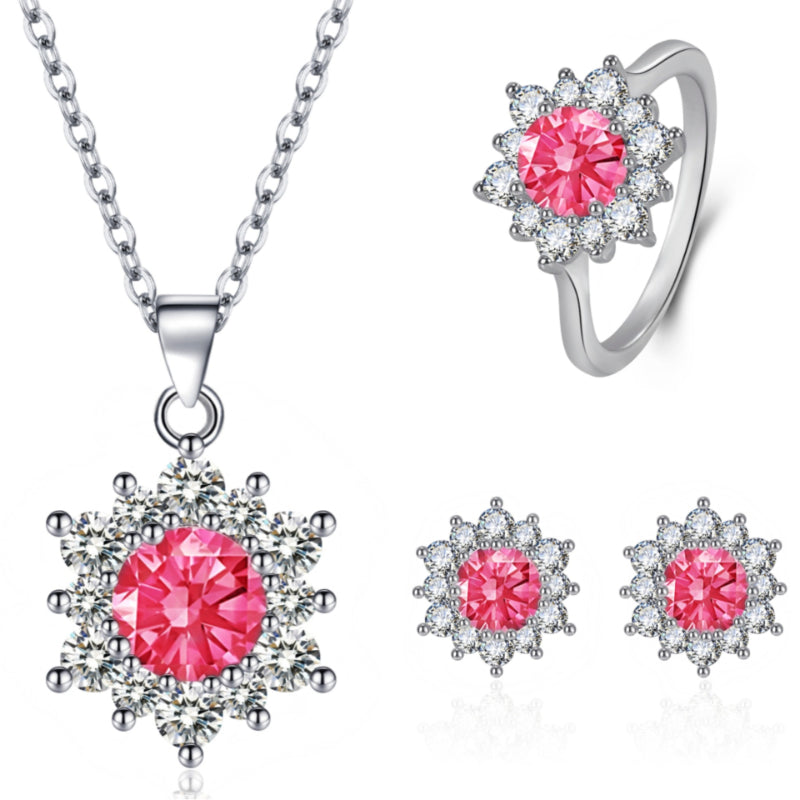 Elegant snowflake jewelry set by cj with pink center stones; includes necklace pendant, ring, and stud earrings