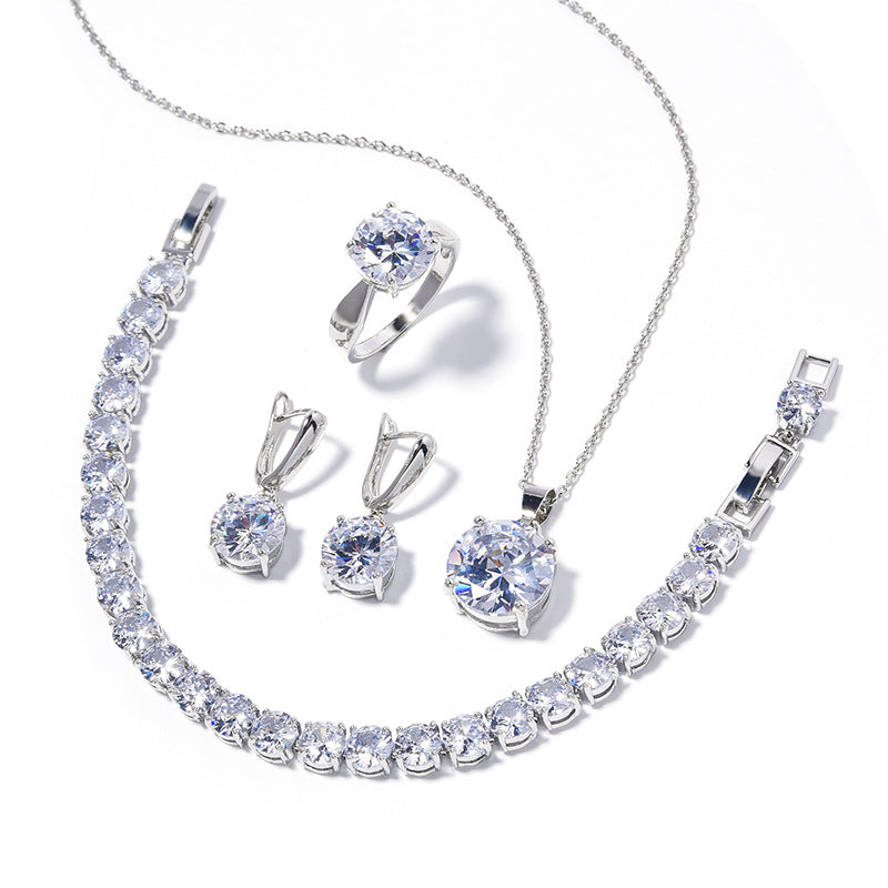cj silver-tone crystal jewelry set: necklace, bracelet, ring, and earrings with round clear stones.