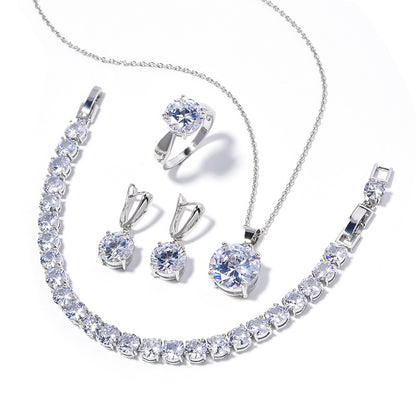 cj silver-tone crystal jewelry set: necklace, bracelet, ring, and earrings with round clear stones.