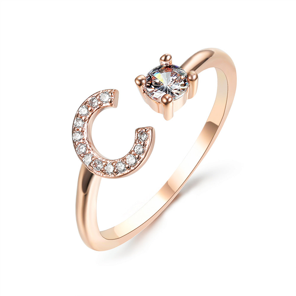 Rose gold adjustable initial C ring with pave crystals and a solitaire stone