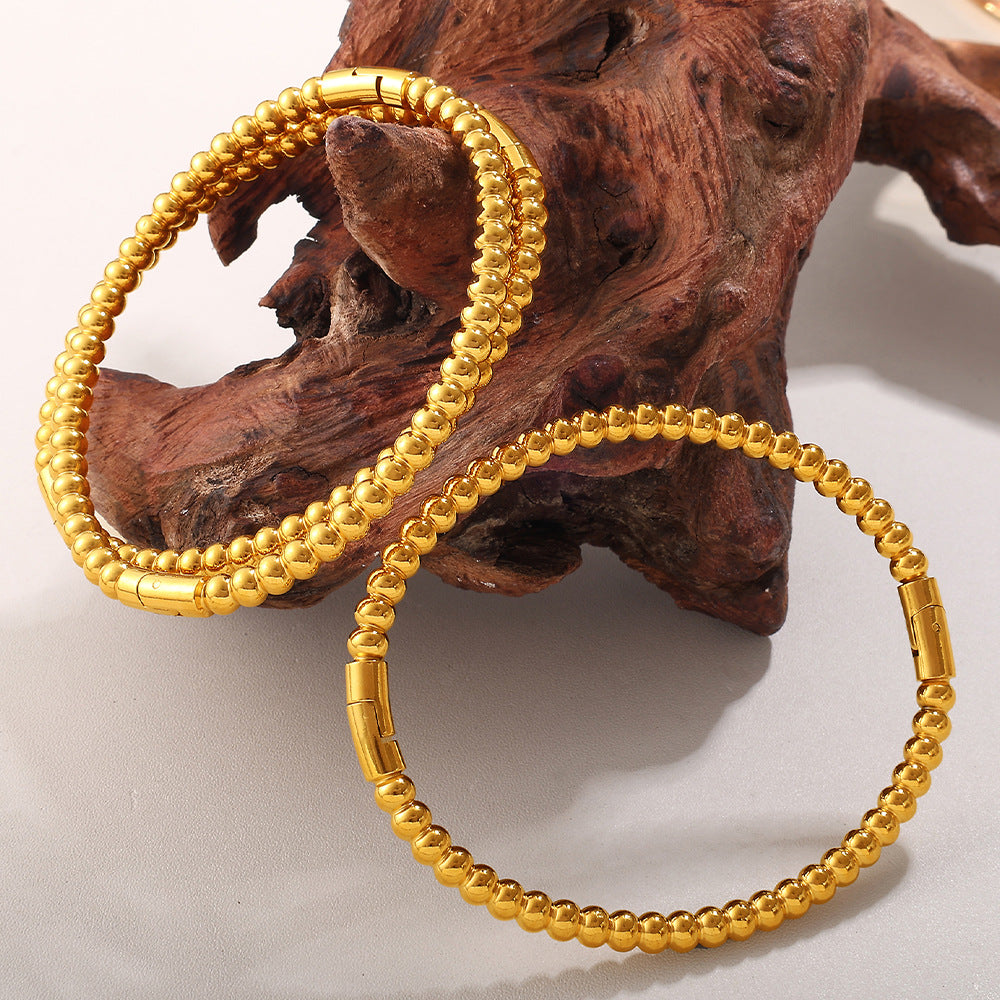Buckle bracelets by CJ; 2 gold-tone alloy beaded bracelets
