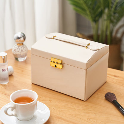 edenista cream three-layer drawer jewelry storage box with gold latch and top handle on a wooden table