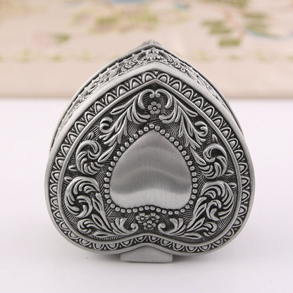Heart-shaped jewelry storage box with ornate silver-tone engraving for brooches and rings, antique finish