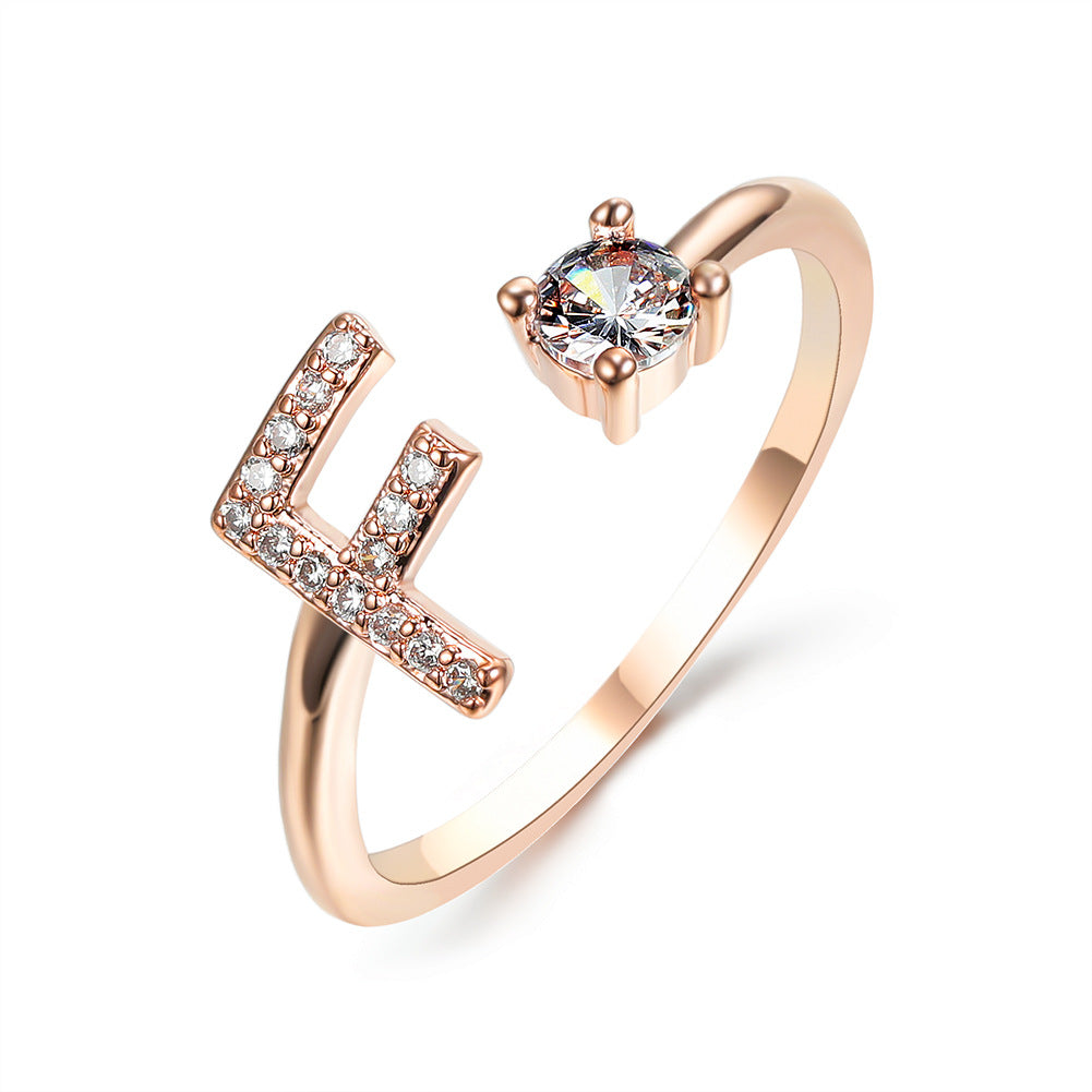 Rose gold adjustable initial-letter ring with L-shaped crystal accent and solitaire gemstone