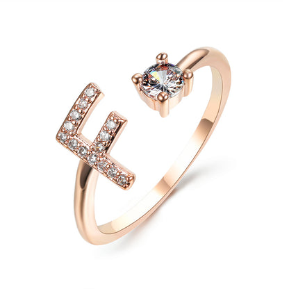 Rose gold adjustable initial-letter ring with L-shaped crystal accent and solitaire gemstone