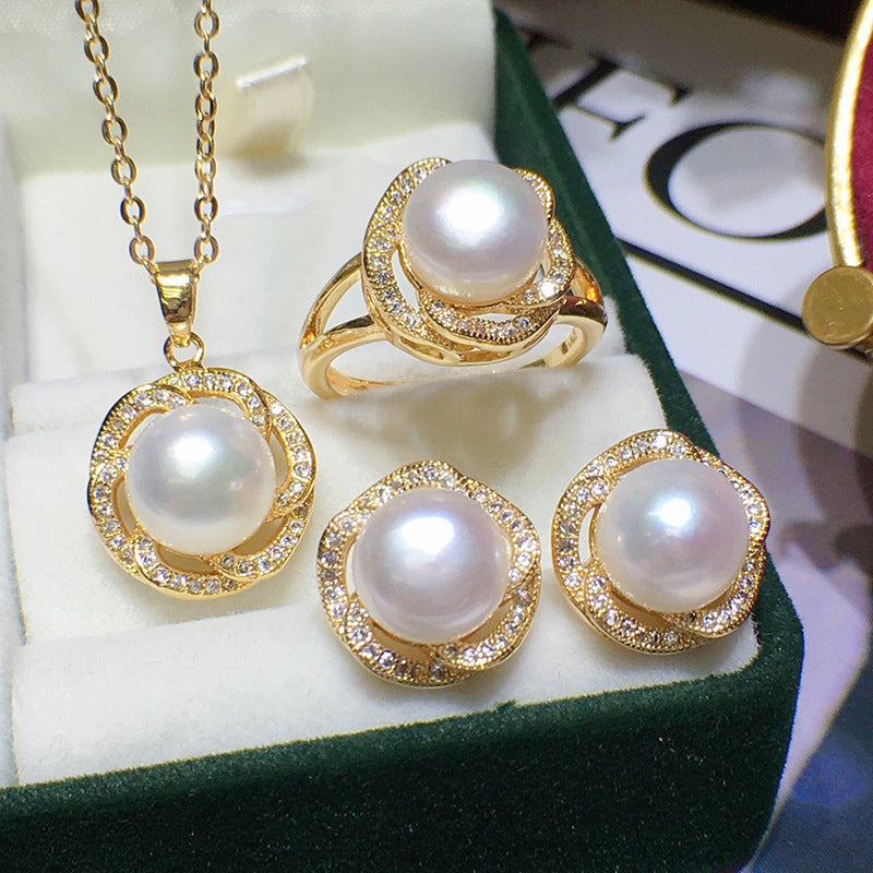 Freshwater pearl jewelry set in gold-tone with pave crystal halos; necklace pendant and three rings