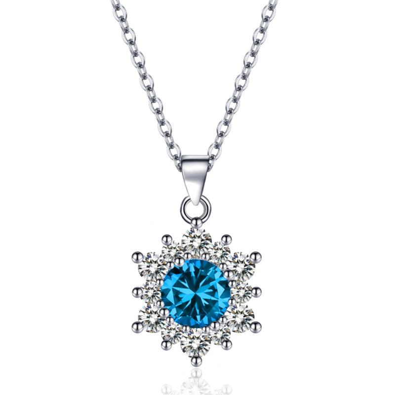 Snowflake pendant necklace with a blue center stone surrounded by clear crystals on a silver chain.