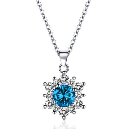 Snowflake pendant necklace with a blue center stone surrounded by clear crystals on a silver chain.