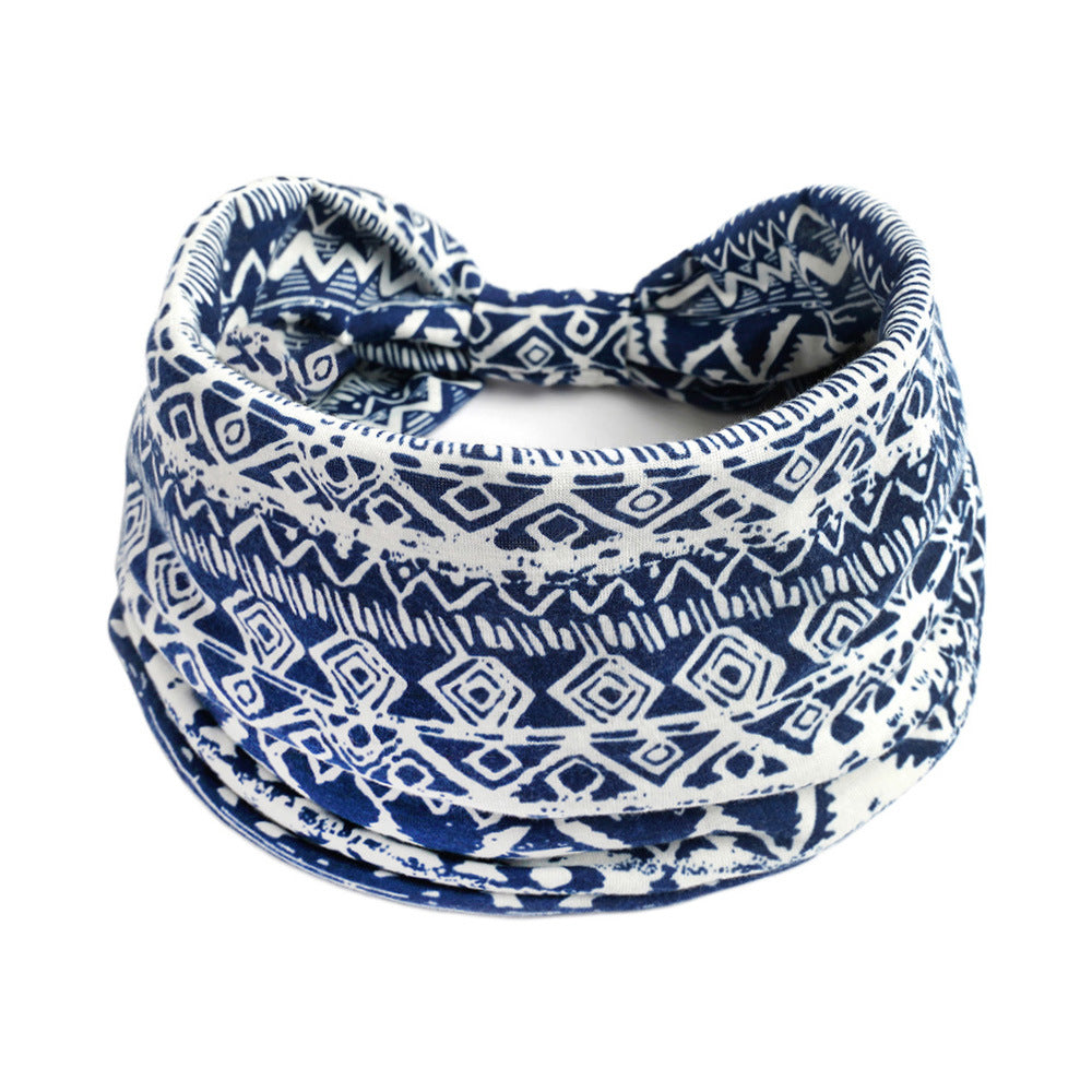 Yoga headband by CJ in navy blue and white Bohemian geometric print, a soft tubular headwear accessory for workouts.