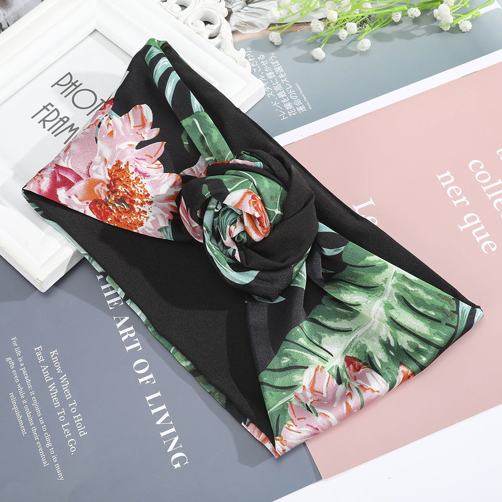 Silk hairband scarf with tropical pink floral print and green leaves on black background