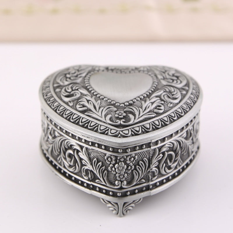 Heart-shaped silver-tone jewelry storage box by edenista with intricate floral engraving.