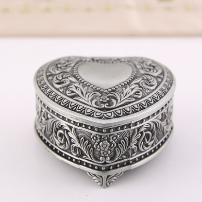 Heart-shaped silver-tone jewelry storage box by edenista with intricate floral engraving.
