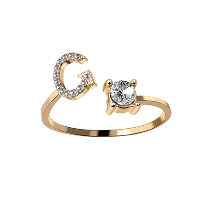 Gold-tone adjustable two-ring set featuring a crystal-studded C initial and a solitaire stone ring