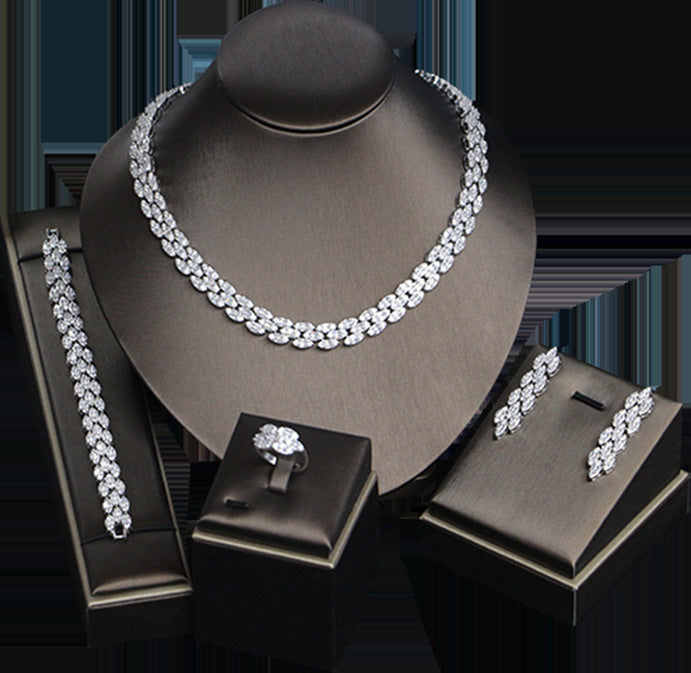 Bridal zircon jewelry set, four-piece: necklace, bracelet, ring and earrings in silver-tone