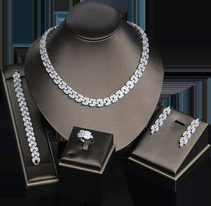 Bridal zircon jewelry set, four-piece: necklace, bracelet, ring and earrings in silver-tone