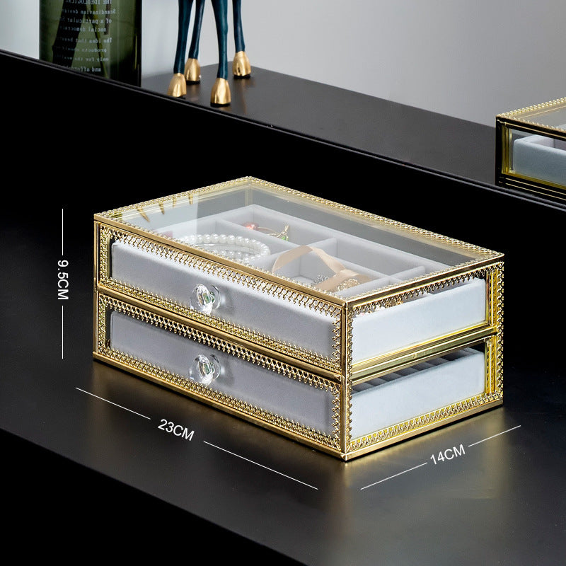 Copper-edge glass jewelry storage box with two drawers and crystal knobs, jewelry visible inside