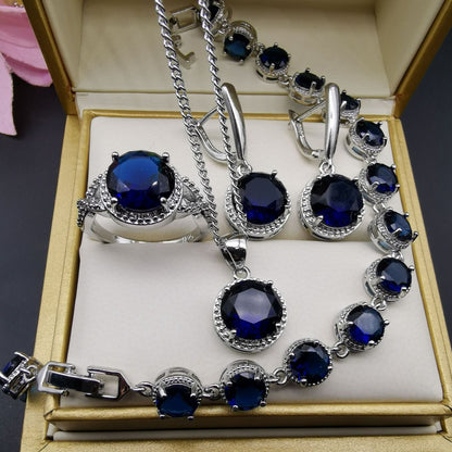 European and American style 4-piece jewelry set with deep blue round stones in silver-tone settings by CJ