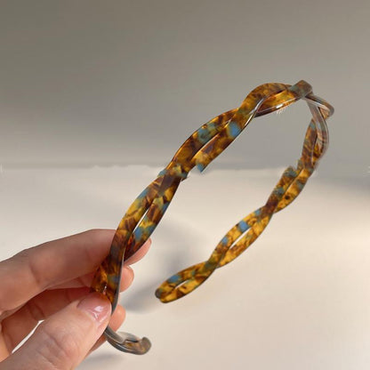 Acetic Acid Cross minimalist hairband in tortoiseshell amber-blue pattern, plastic