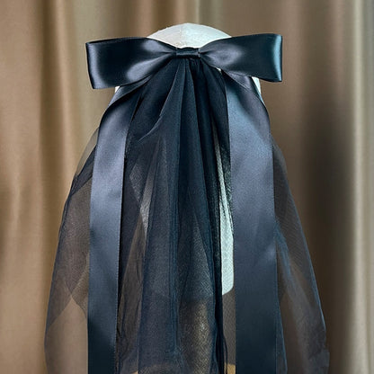 Bow veil with black satin bow; sheer black tulle drape on mannequin