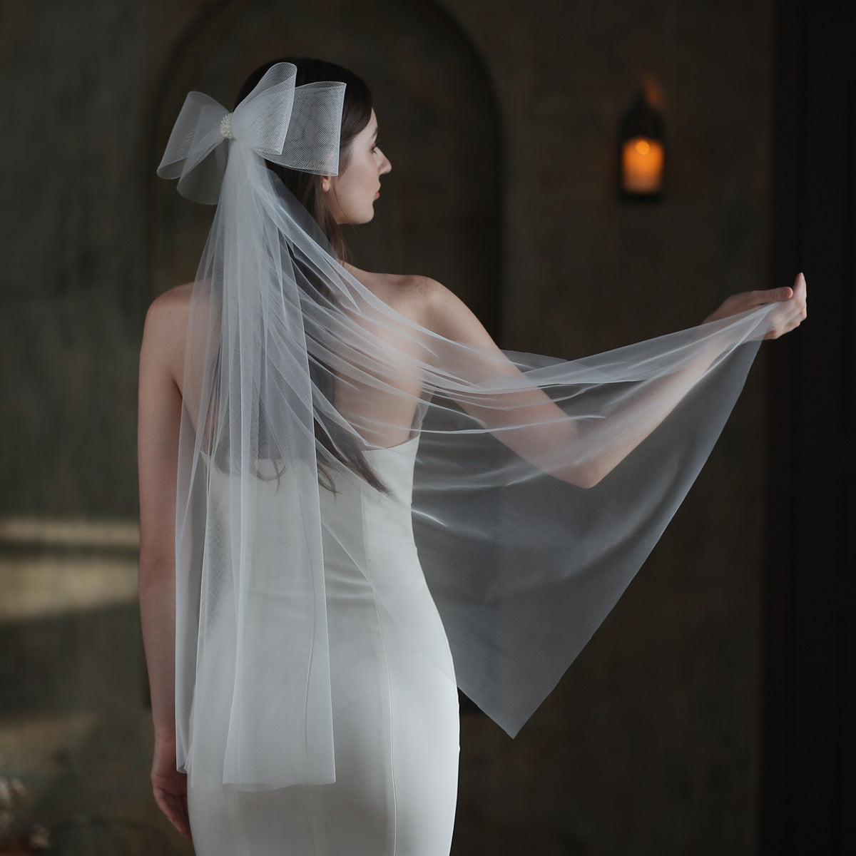 Super Fairy Elastic Mesh Bow Bridal Veil, white mesh with a large bow worn by a bride