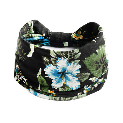 Bohemian floral yoga headband in black with blue hibiscus and green leaves; elastic, absorbent CJ brand