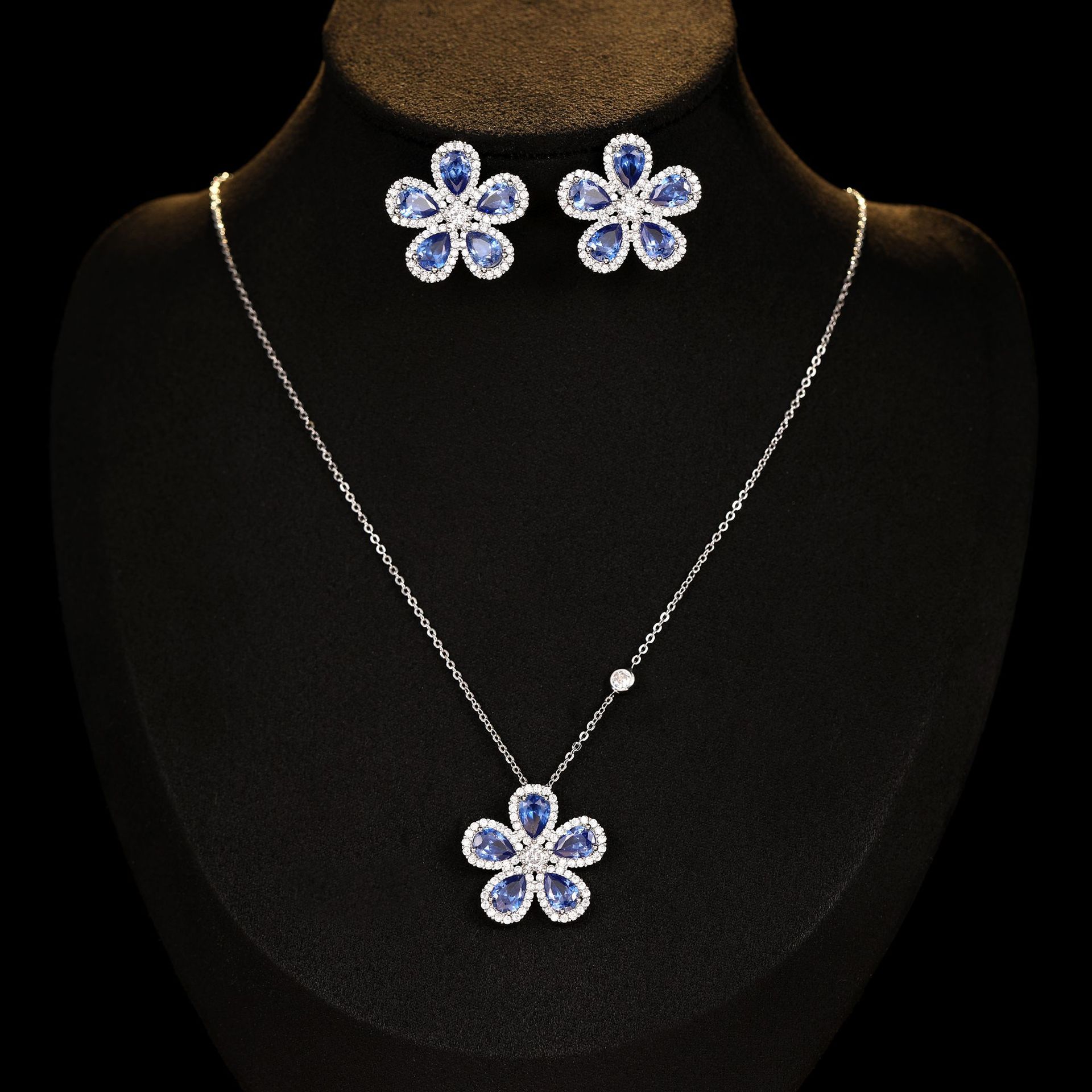 Sunflower zircon jewelry set with blue petals and clear crystals; includes earrings and pendant necklace.