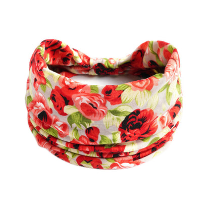 Yoga headband with red floral print and green leaves on white fabric