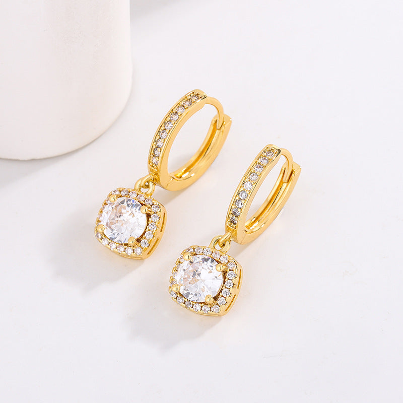 Earrings by CJ: gold-tone hoops with square halo and moissanite center stones, pair.