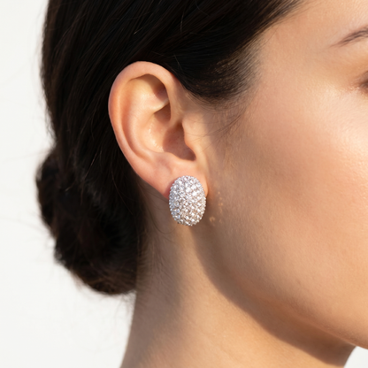 Earrings cj crystal-studded silver hoop on a woman's ear