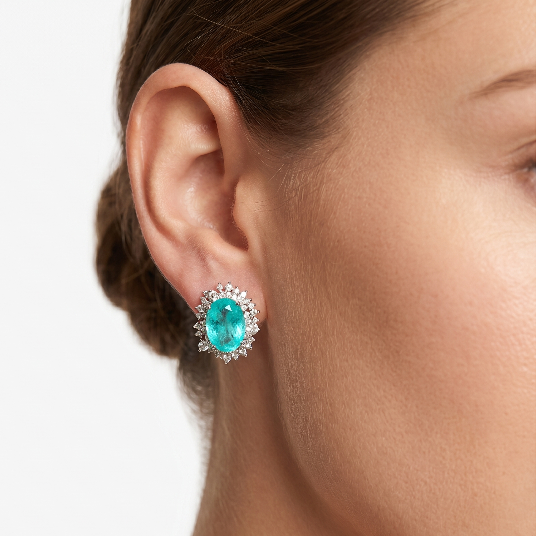 Vintage earrings featuring a turquoise oval centerpiece with a diamond halo