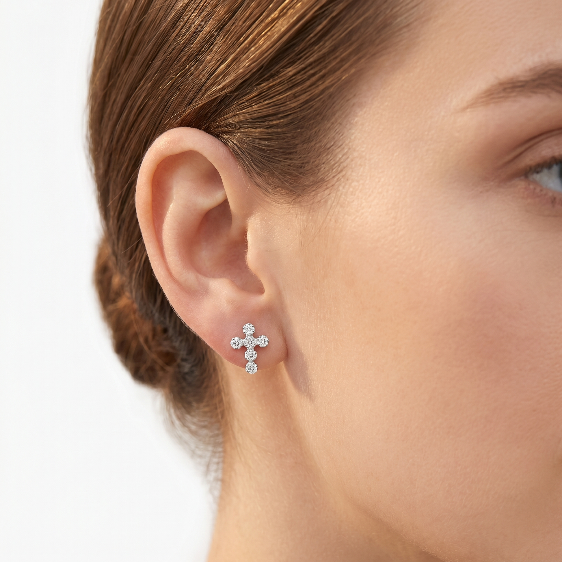 Cross drop earrings by edenista in sterling silver with pave crystals; small stud above
