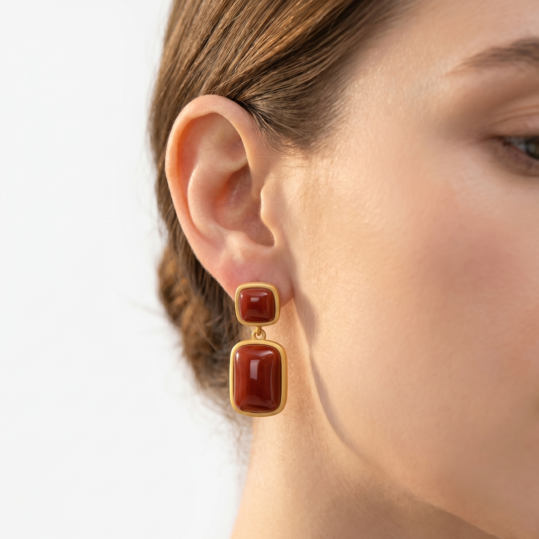 Jade Sapphire earrings with gold-tone frames and red rectangular stones, two-stone drop design.
